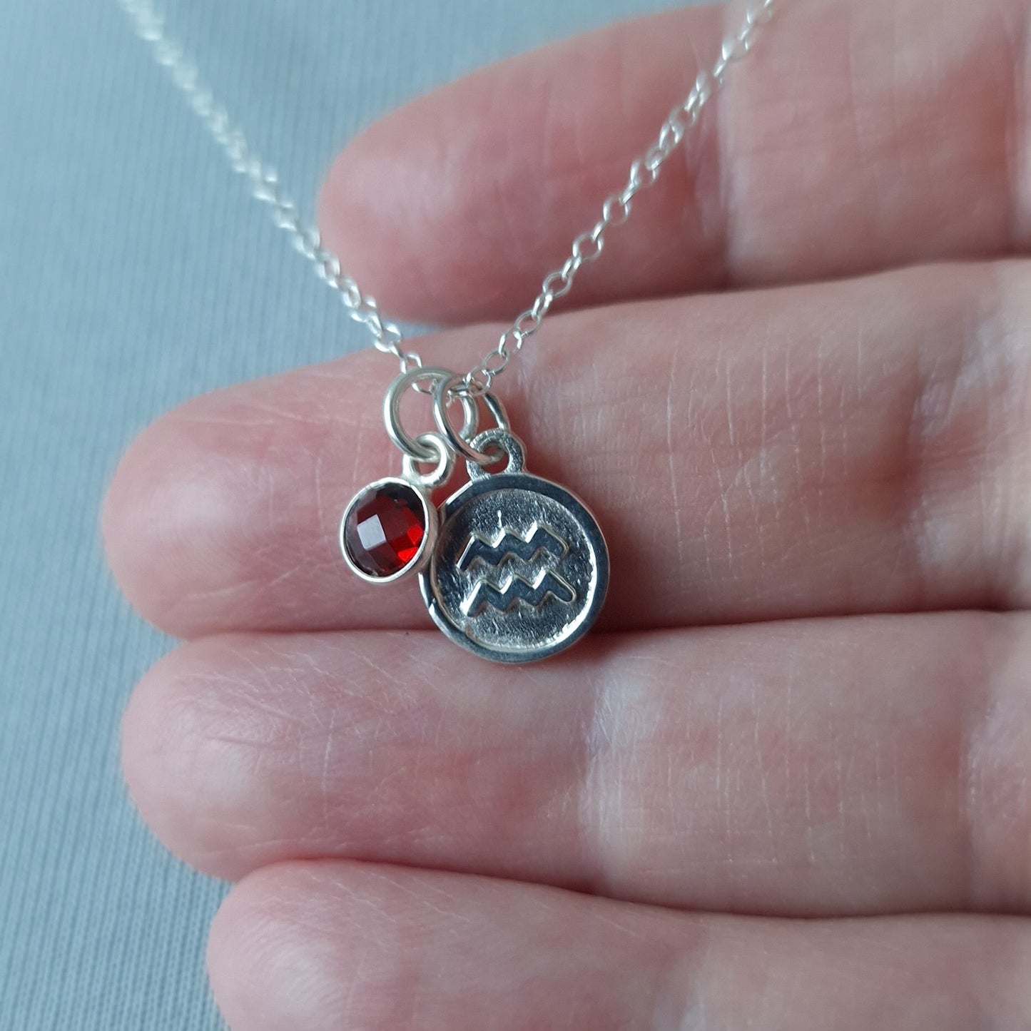 Aquarius and garnet double pendant necklace in sterling silver