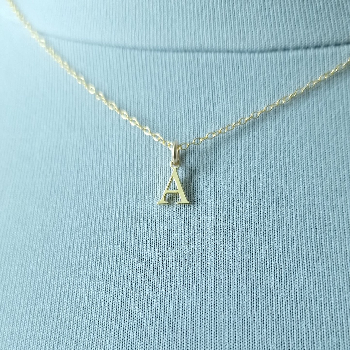 Close up of Gold vermeil silver initial pendant necklace