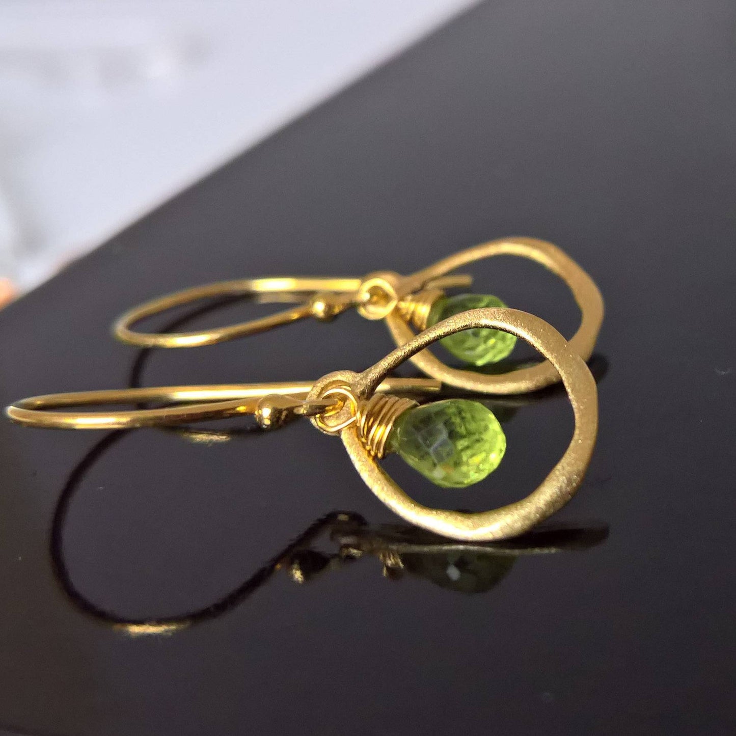 Close up of pair of peridot drop earrings - Marie Nicole Bijoux