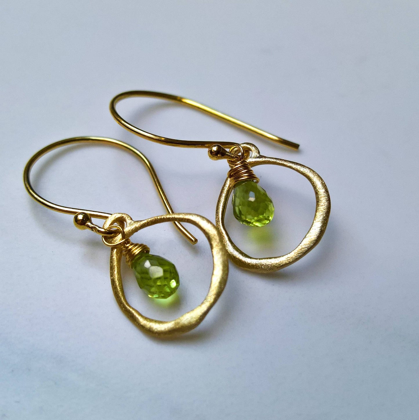 Close up of pair of peridot drop earrings - Marie Nicole Bijoux