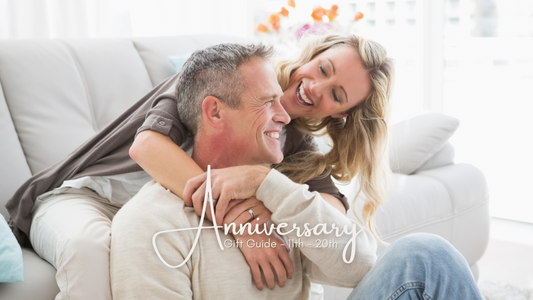 Couple hugging on sofa - anniversary gift guide for Marie Nicole Bijoux
