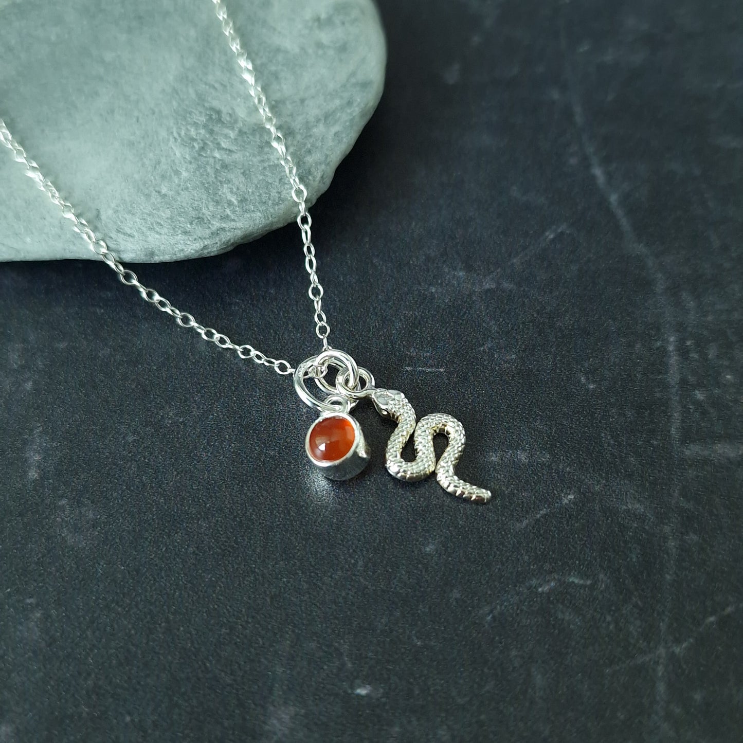 Close up of silver double pendant snake necklace with carnelian birthstone - Marie Nicole Bijoux