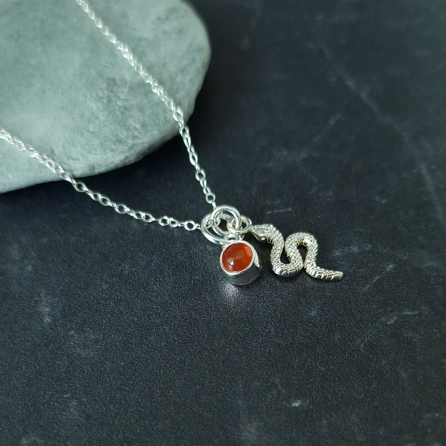 Close up of silver double pendant snake necklace with carnelian birthstone - Marie Nicole Bijoux