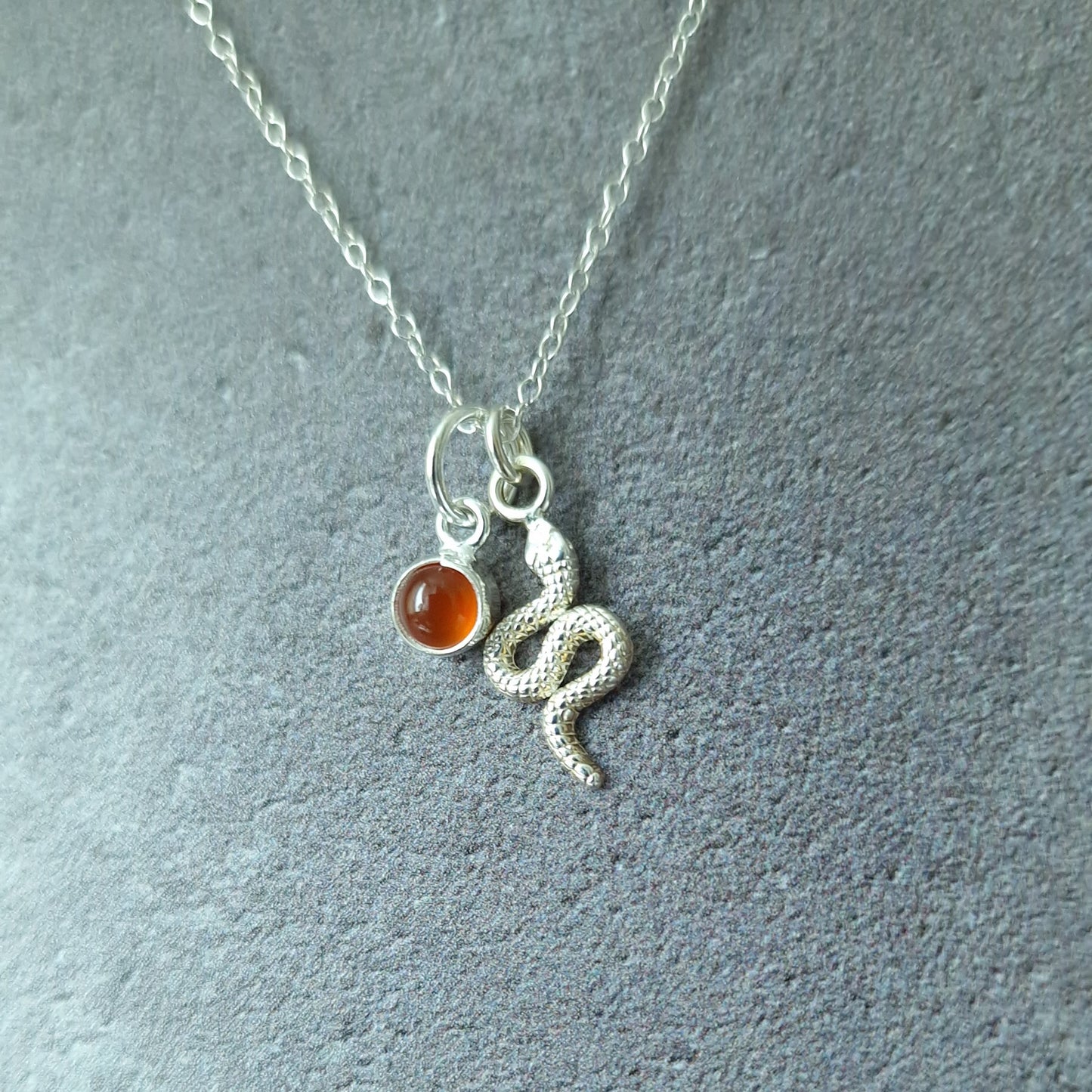 Close up of silver double pendant snake necklace with carnelian birthstone - Marie Nicole Bijoux