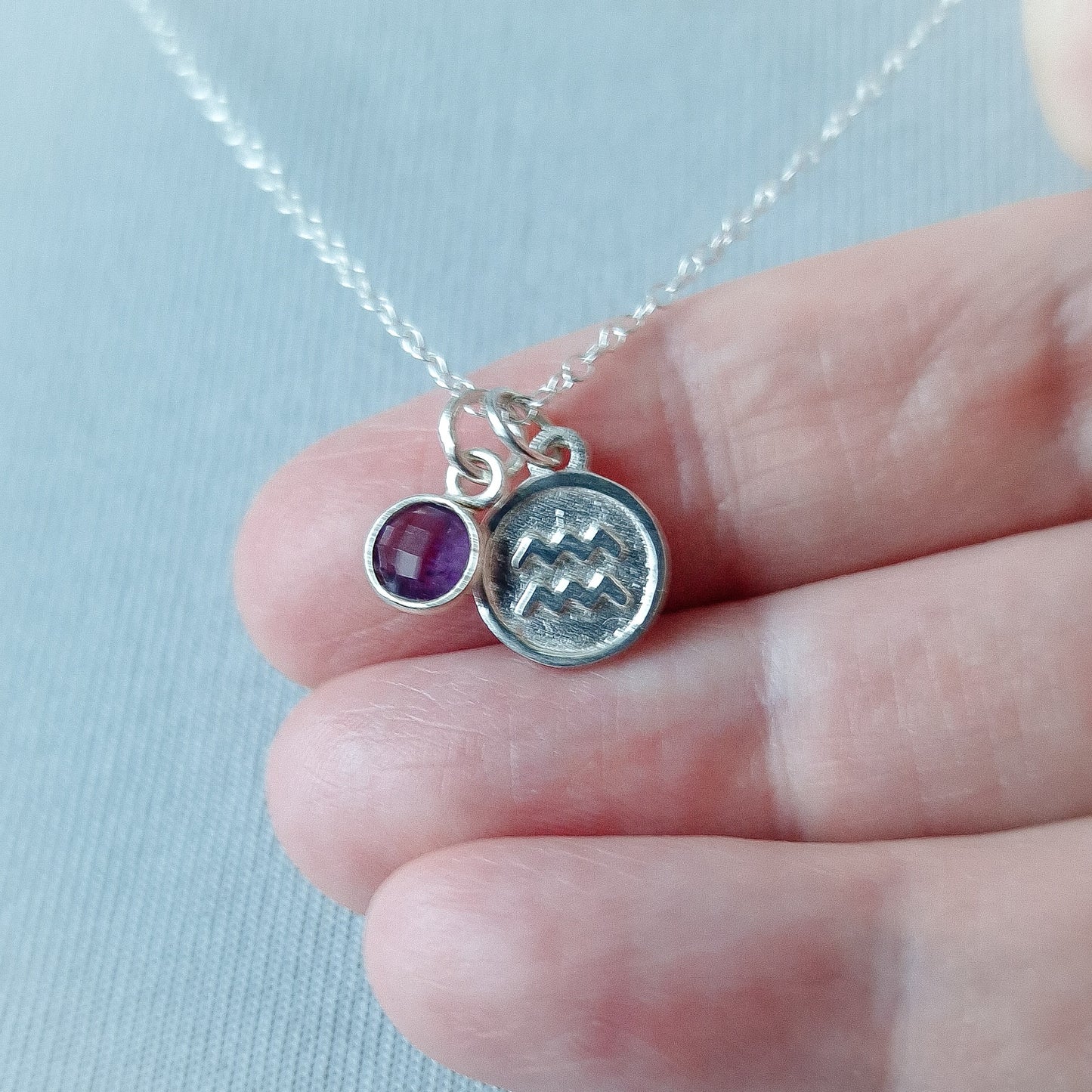 Aquarius and amethyst charm necklace in sterling silver