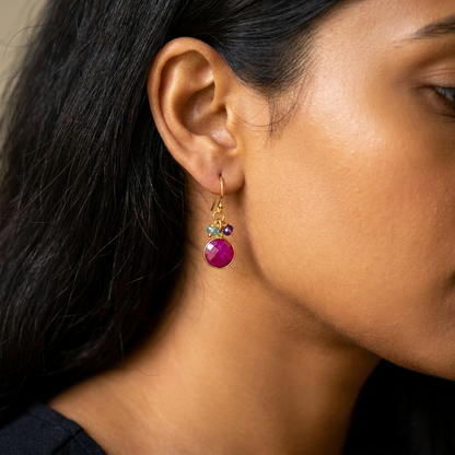 Side profile of a women wearing ruby circle earrings in gold vermeil silver =