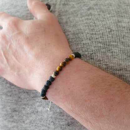 Marie Nicole Bijoux - Close up of man's wrist with a tiger's eye and lava rock silver bracelet